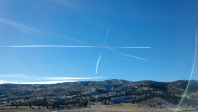Contrails in different directions over the Colorado Front Range.  Photograph by Nick Guy, Dec 30, 2013.